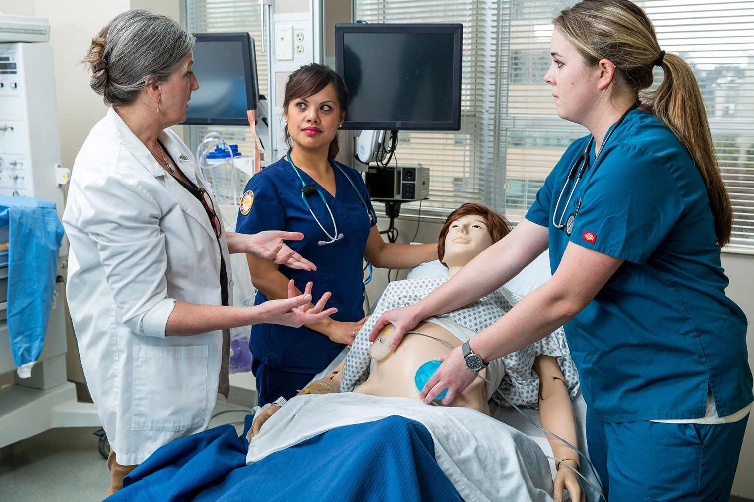 instructor and students examine mannequin